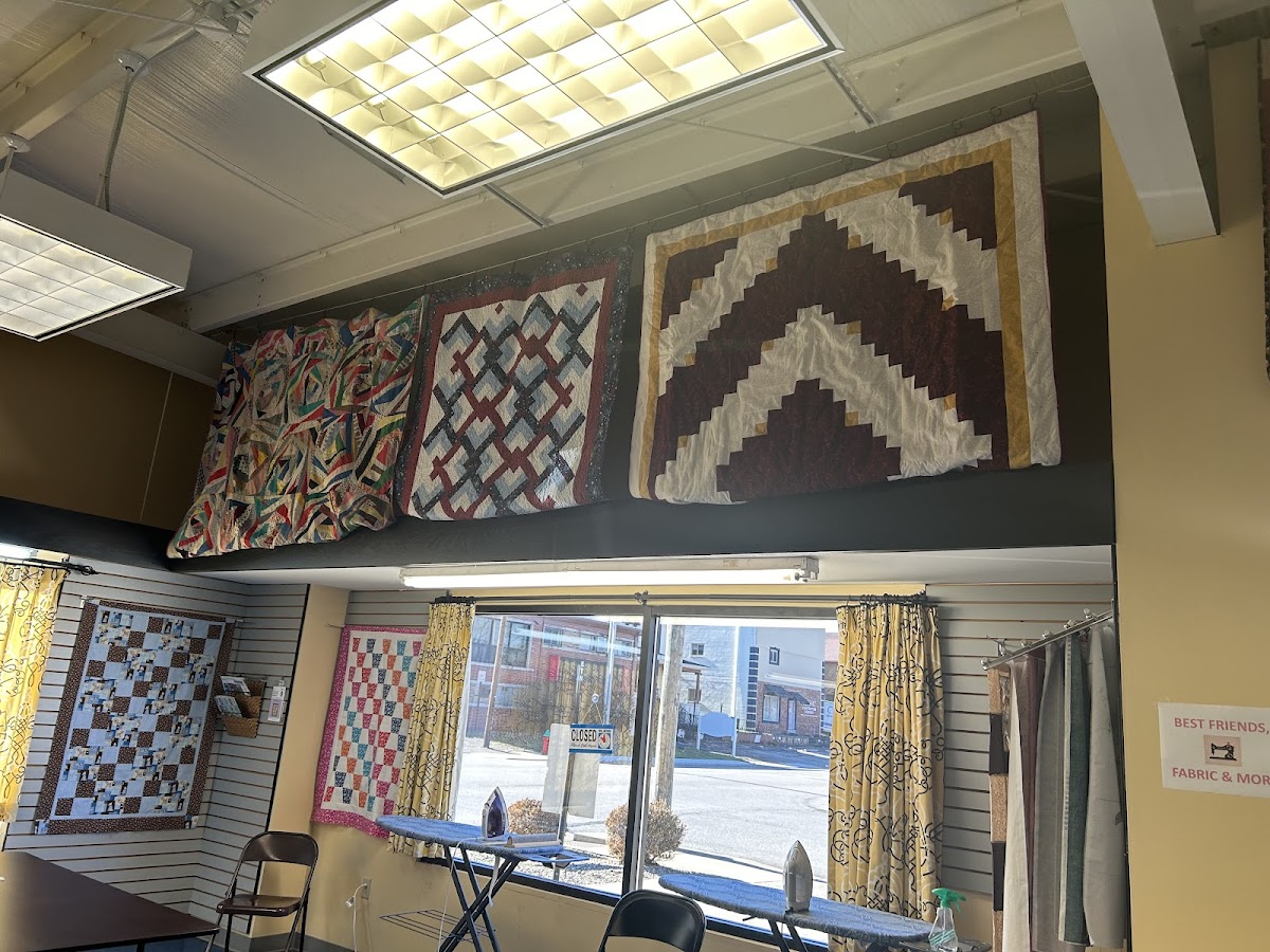 Handmade quilts displayed on the store wall